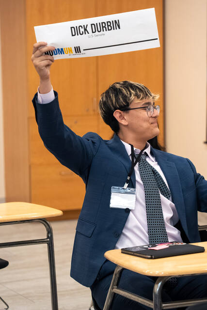 A delegate smiling during committee