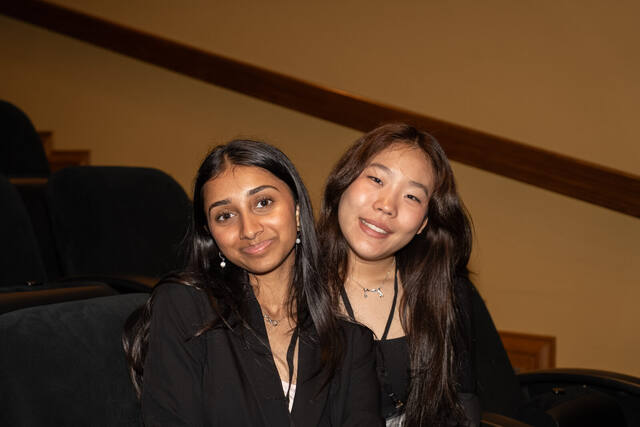 Two delegates sharing a laugh during a caucus