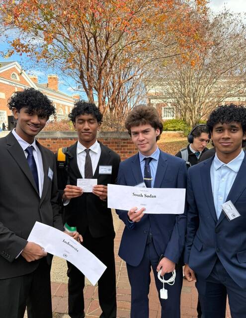 Delegates holding a certificate of recognition at VAMUN